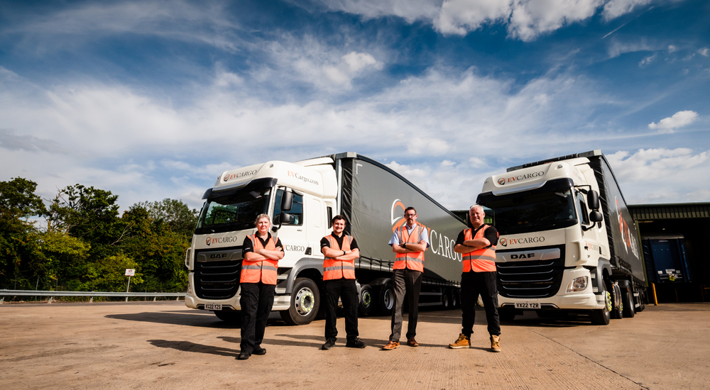 EV Cargo branded trucks with drivers in high-vis vests