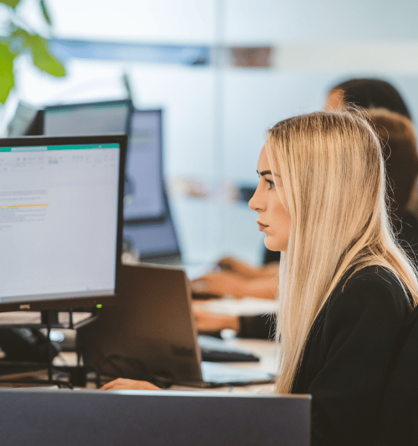 Woman working at desktop computer screen